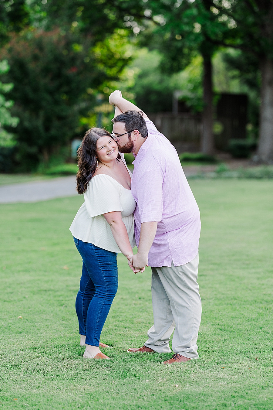 kiss on the cheek during summer ut gardens engagement