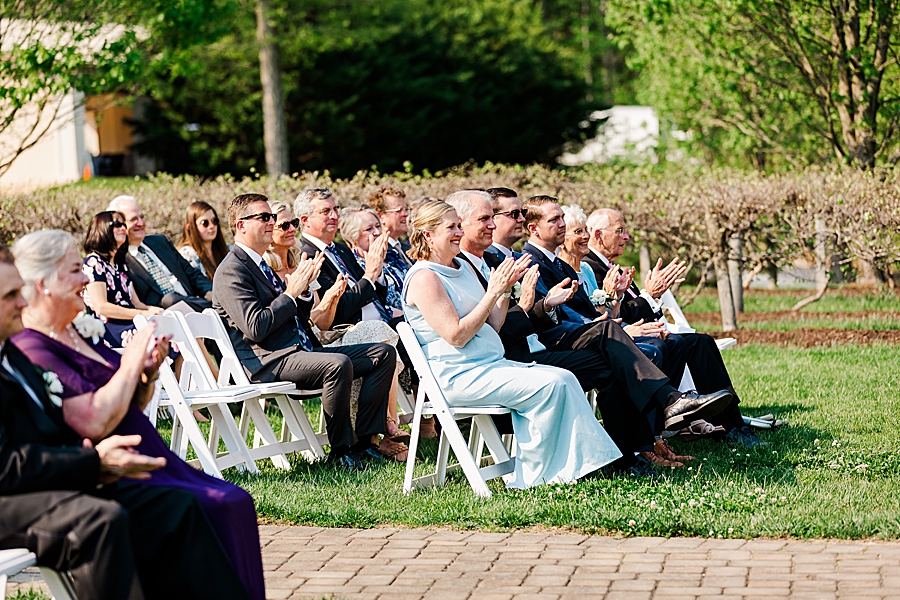 guests clapping during sunny castleton farms wedding
