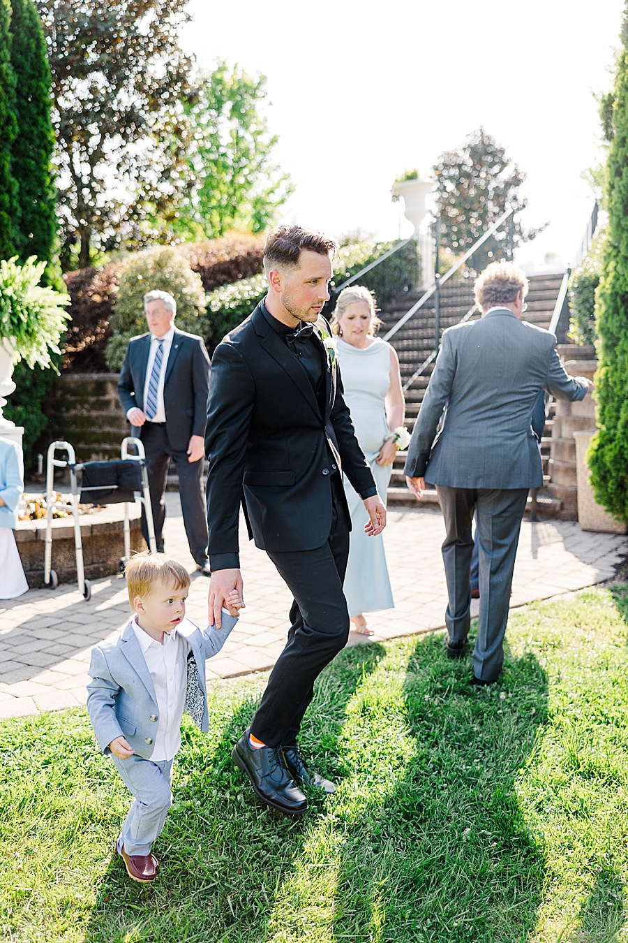groom walking with little boy