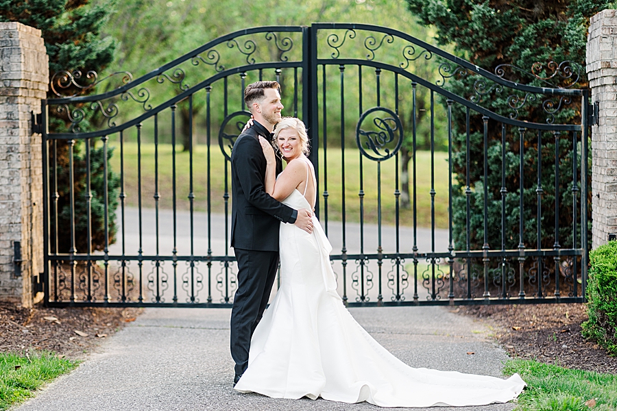 couple in front of black iron gate