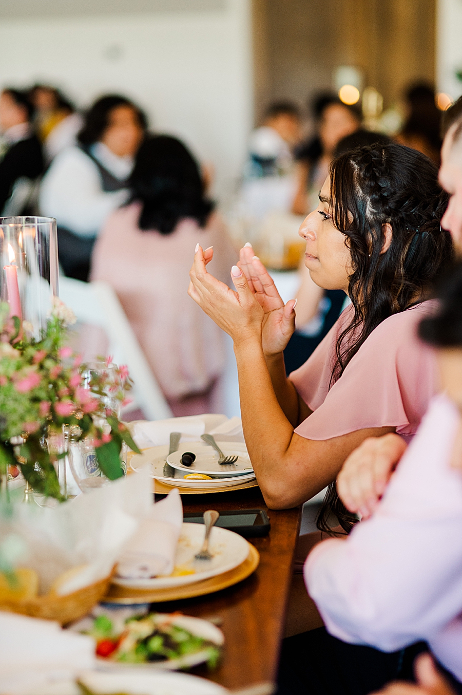 bridesmaid clapping at wedding reception