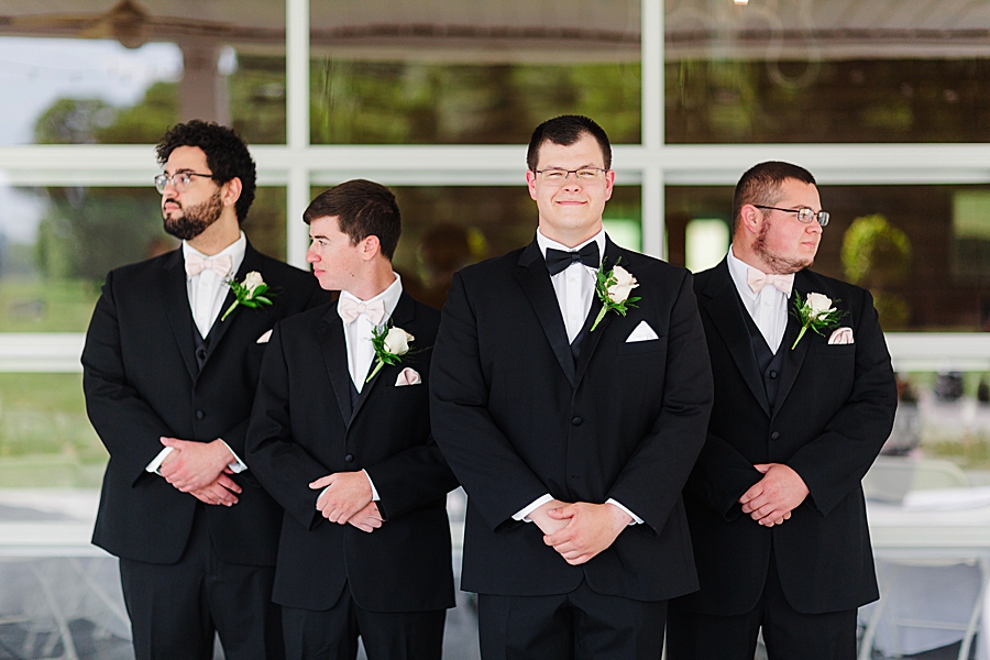 groom and groomsmen at the carriage house