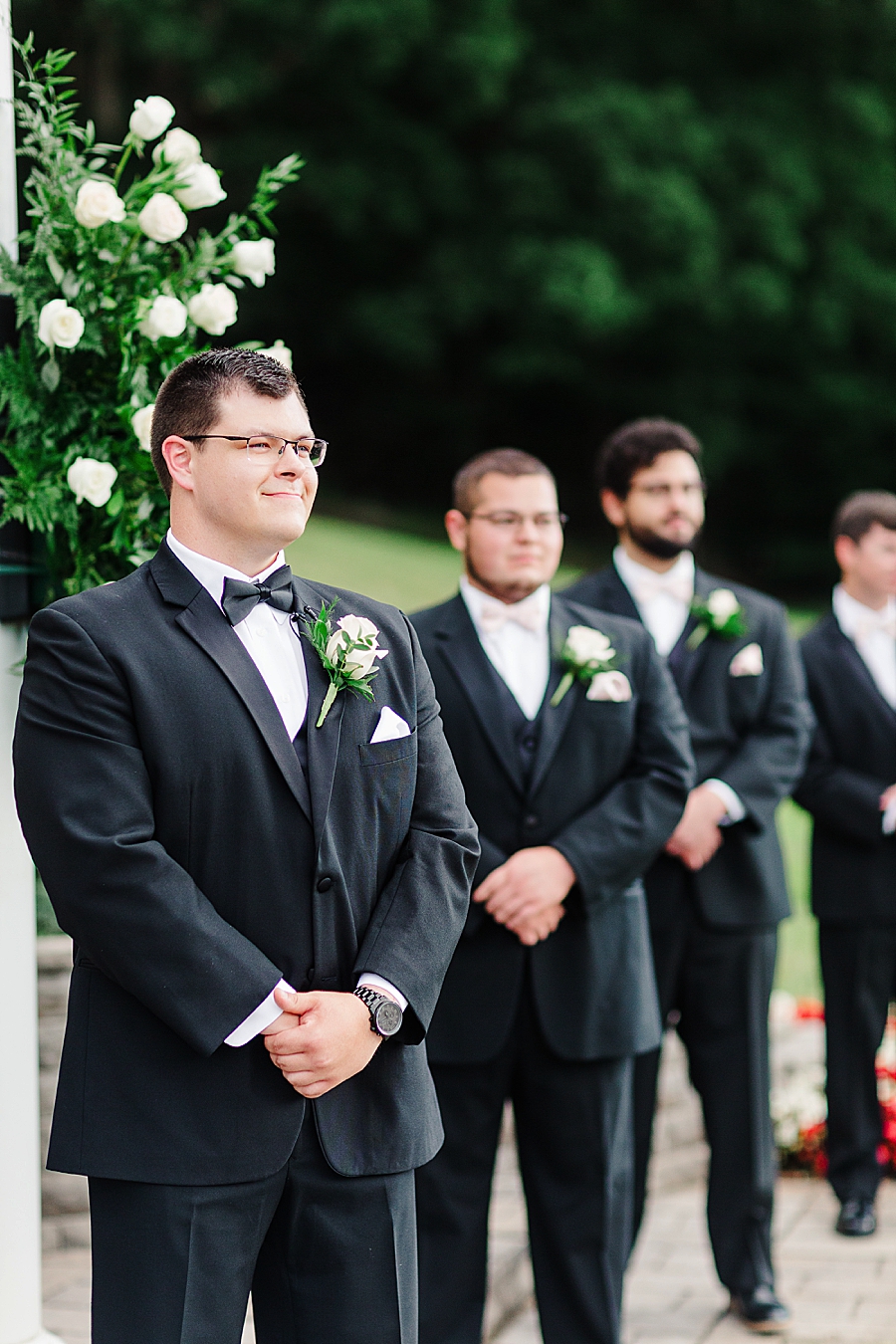 groom standing at altar at the carriage house