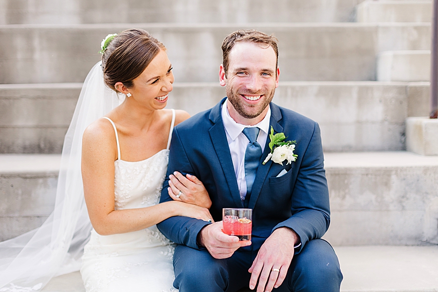 groom holding cocktail