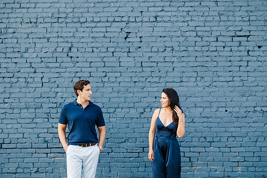 couple by blue brick wall