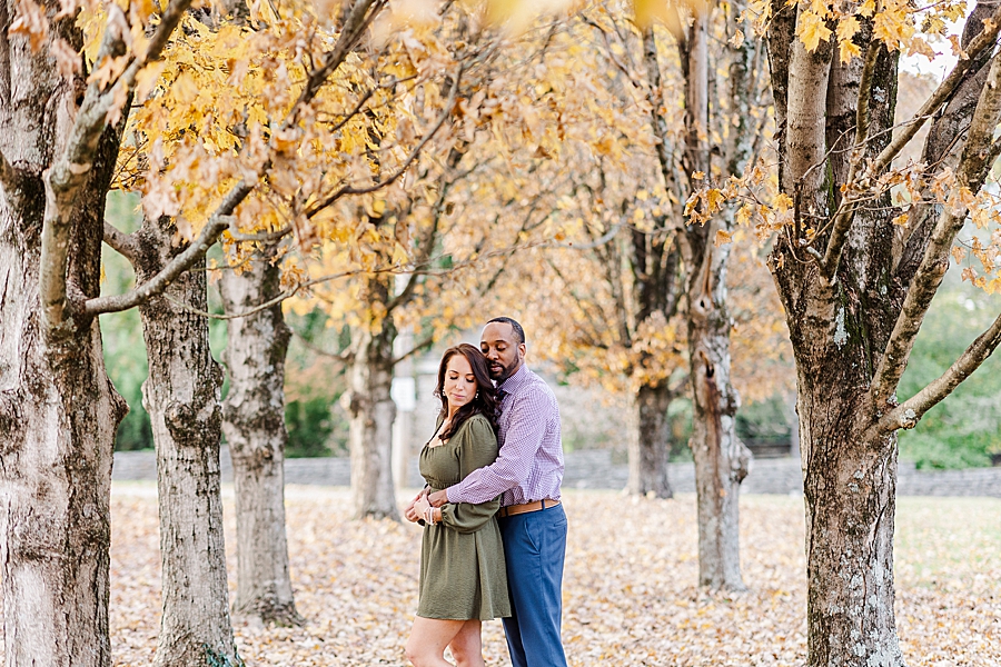 couple standing in leaves