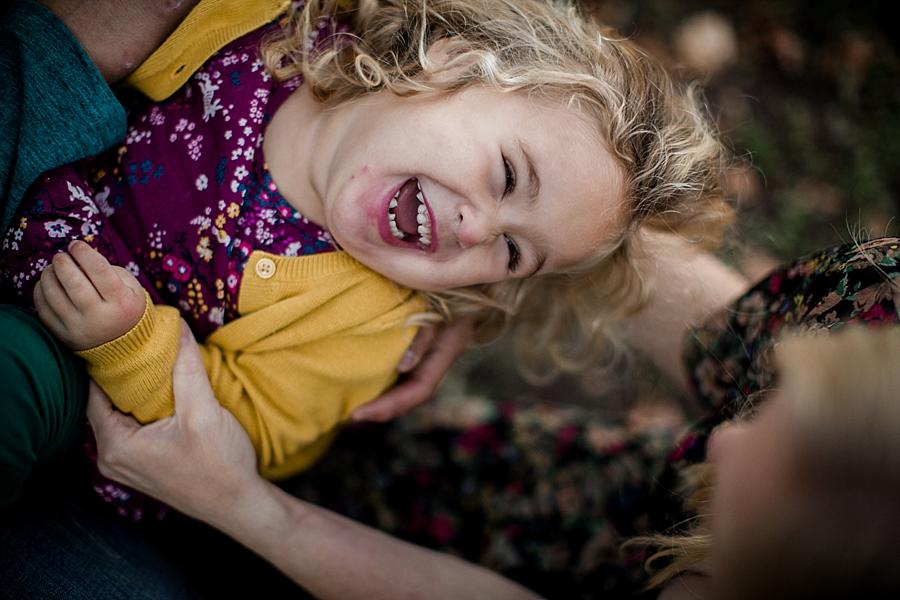 Laying on dad's lap at this Valderrama fall family session by Knoxville Wedding Photographer, Amanda May Photos.