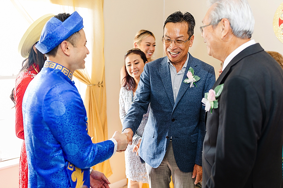 shaking hands at this vietnamese wedding