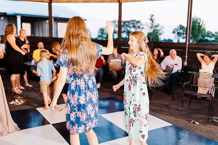 girls dancing at vintage barn reception