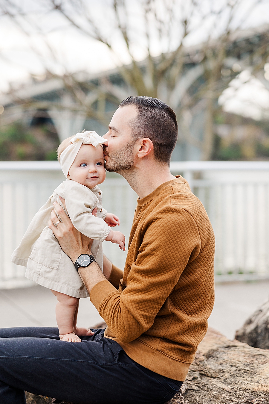 dad kissing daughter's temple