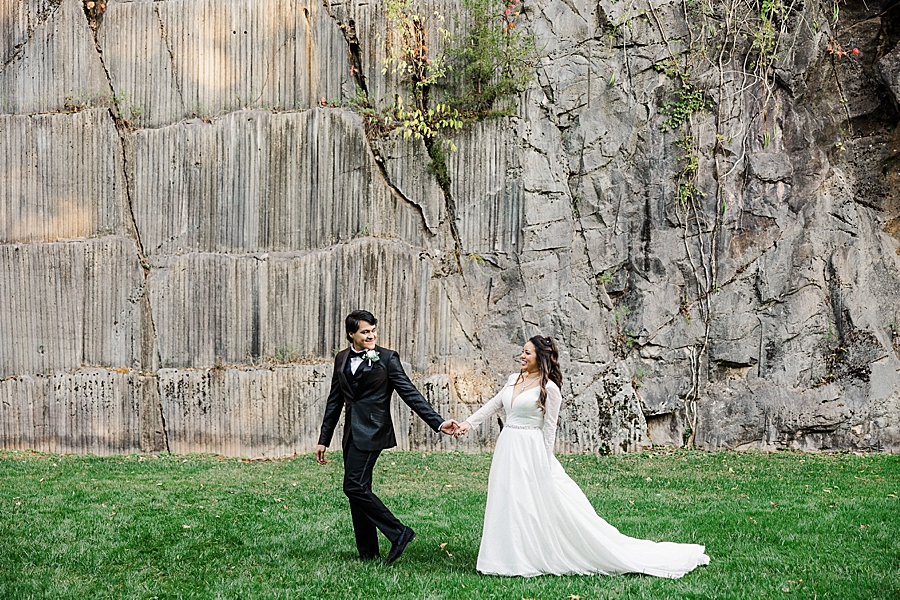 bride and groom walking through quarry