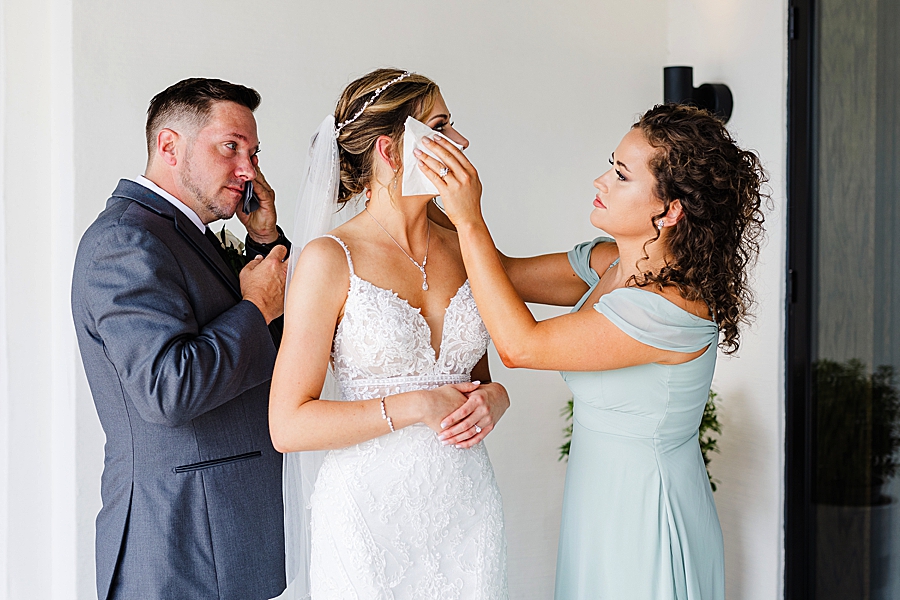 bridesmaid wiping tears at a wedding at the press room