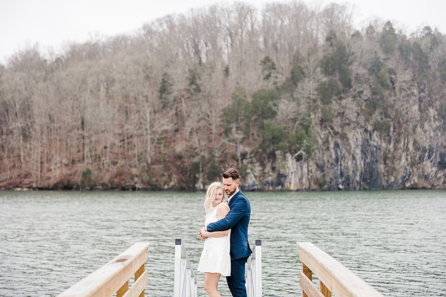 couple by water at winter engagement