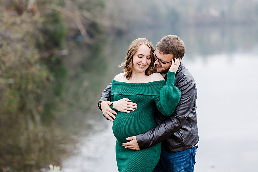 couple snuggling at winter maternity