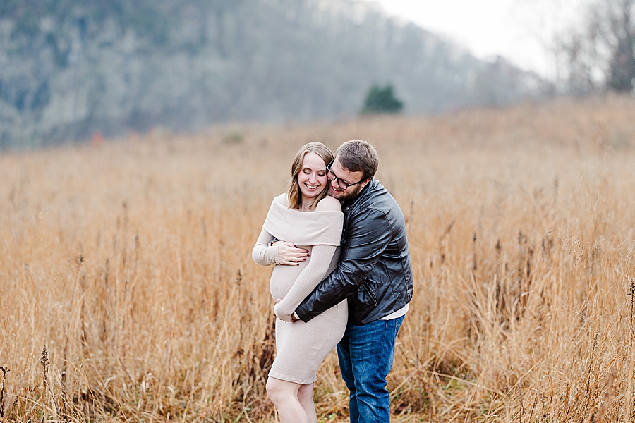 couple in golden meadow at winter maternity