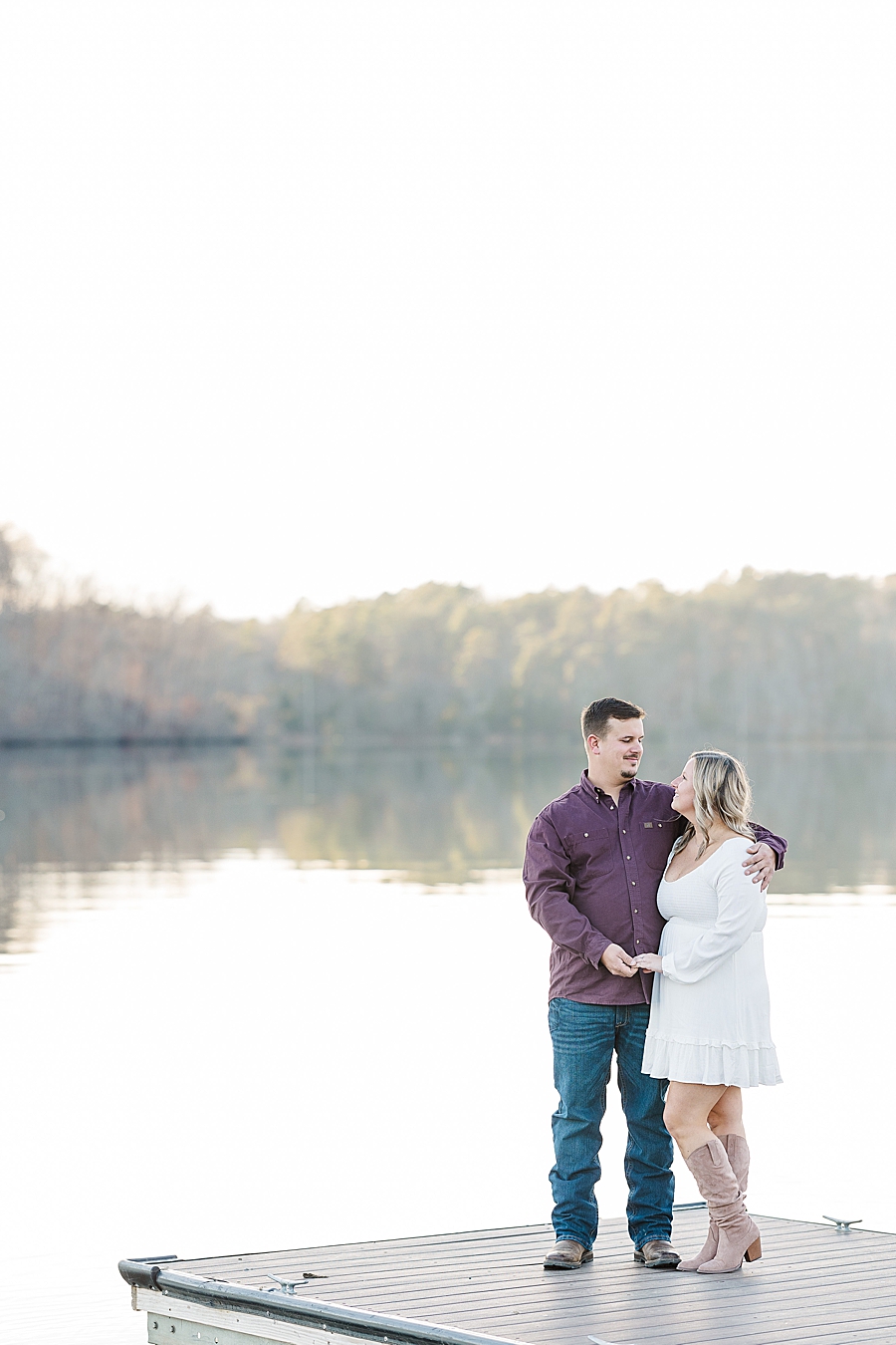 couple on dock at winter melton hill engagement