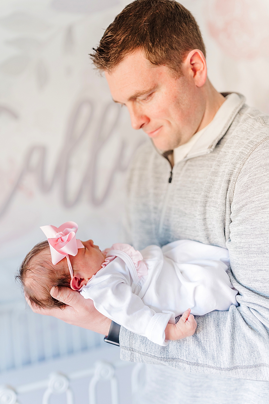 dad holding baby girl dreamy newborn session