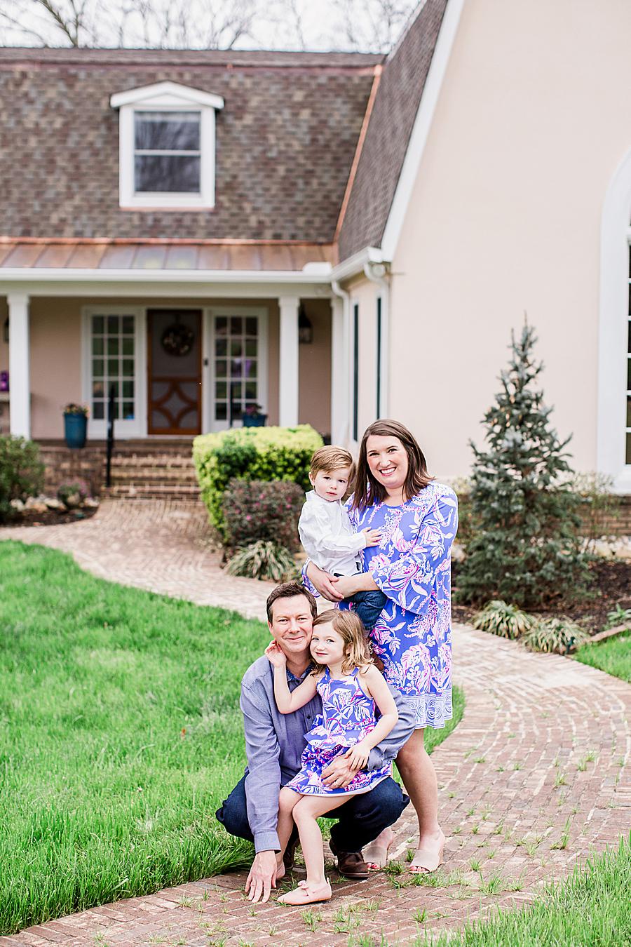 family in matching outfits at front porch project