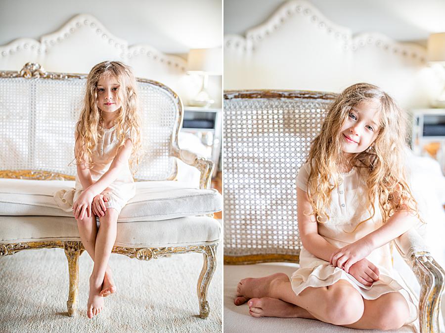 oldest daughter sitting on couch during lifestyle newborn session