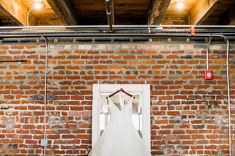 wedding dress hanging up at the mill & mine