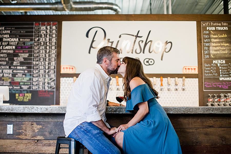 Kissing at this Printshop Brewery engagement by Knoxville Wedding Photographer, Amanda May Photos.
