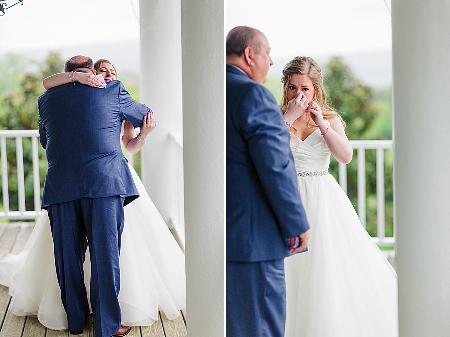 Bride hugging father at rainy castleton farms wedding