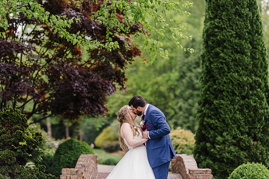 Kissing at rainy castleton farms wedding