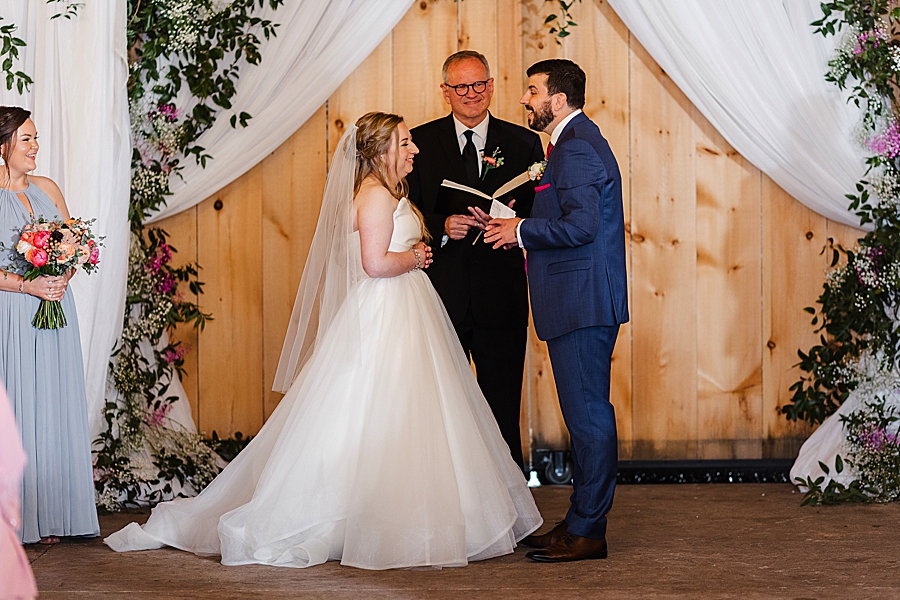 Exchanging vows at rainy castleton farms wedding