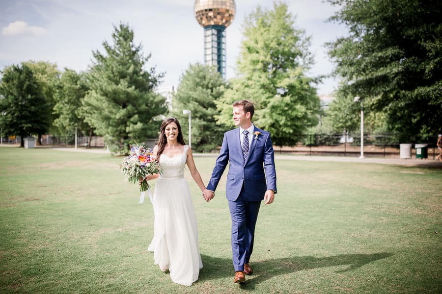 Bride and groom walking holding hands at this Jackson Terminal Wedding by Knoxville Wedding Photographer, Amanda May Photos.