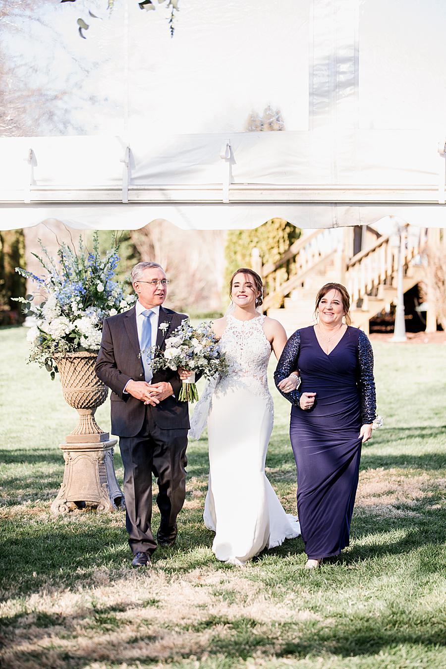 bride walking down the aisle at her spring wedding at castleton