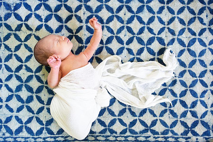 baby on blue patterned rug