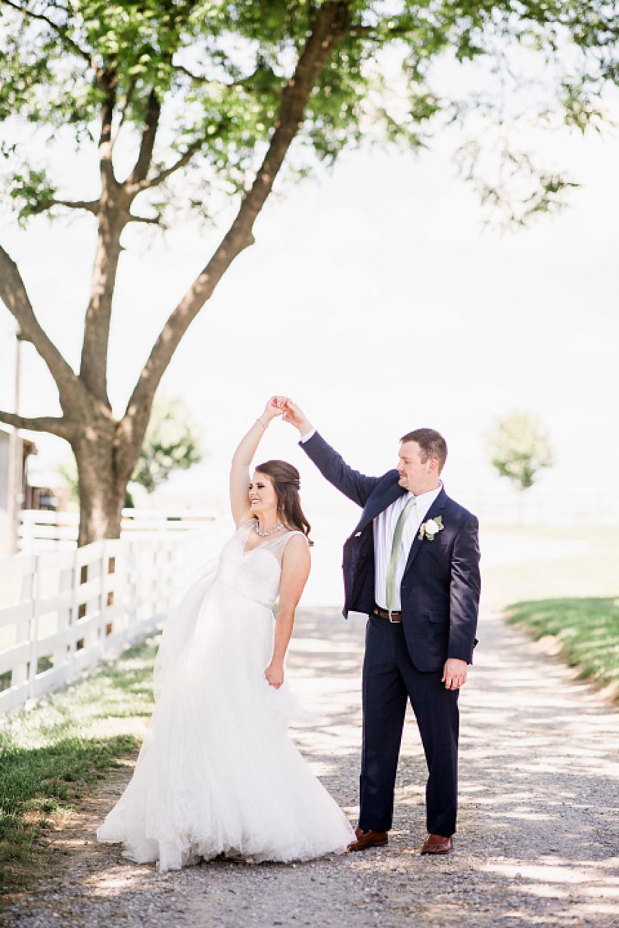 bride and groom dancing at the white rose