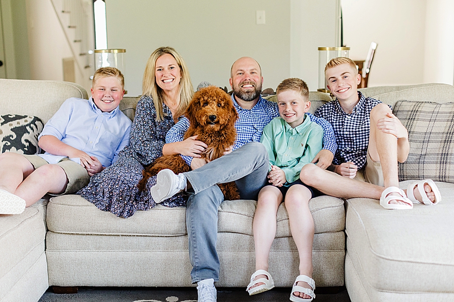 family and dog sitting on the couch at west knoxville lifestyle session