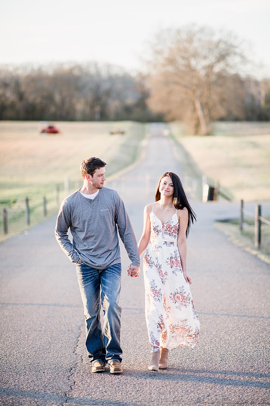 couple holding hands and walking